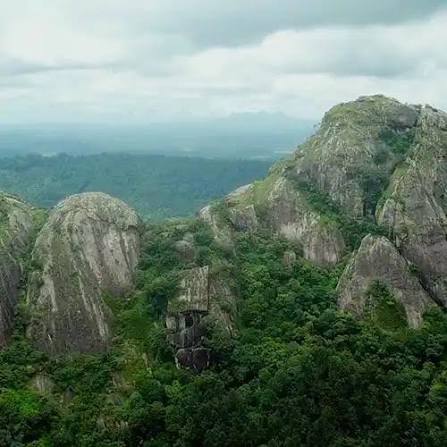 Visitors inside Edakkal Caves, the split-rock shelters of Wayanad
