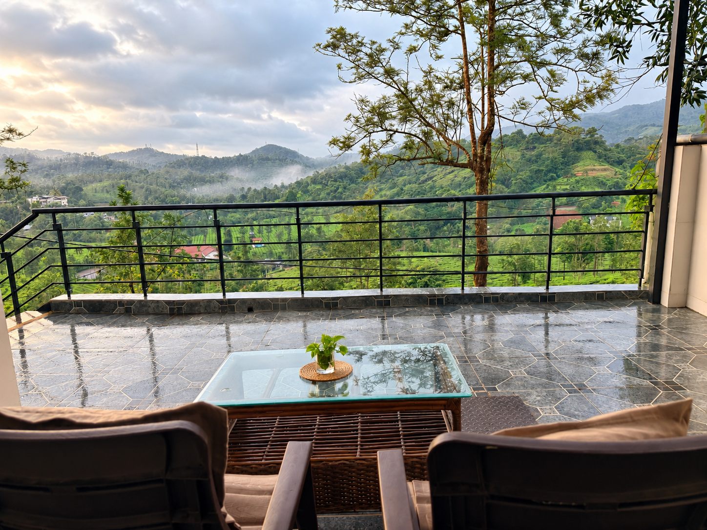 Balcony seating at the 1 BHK overlooking misty green valleys around Green Peaks