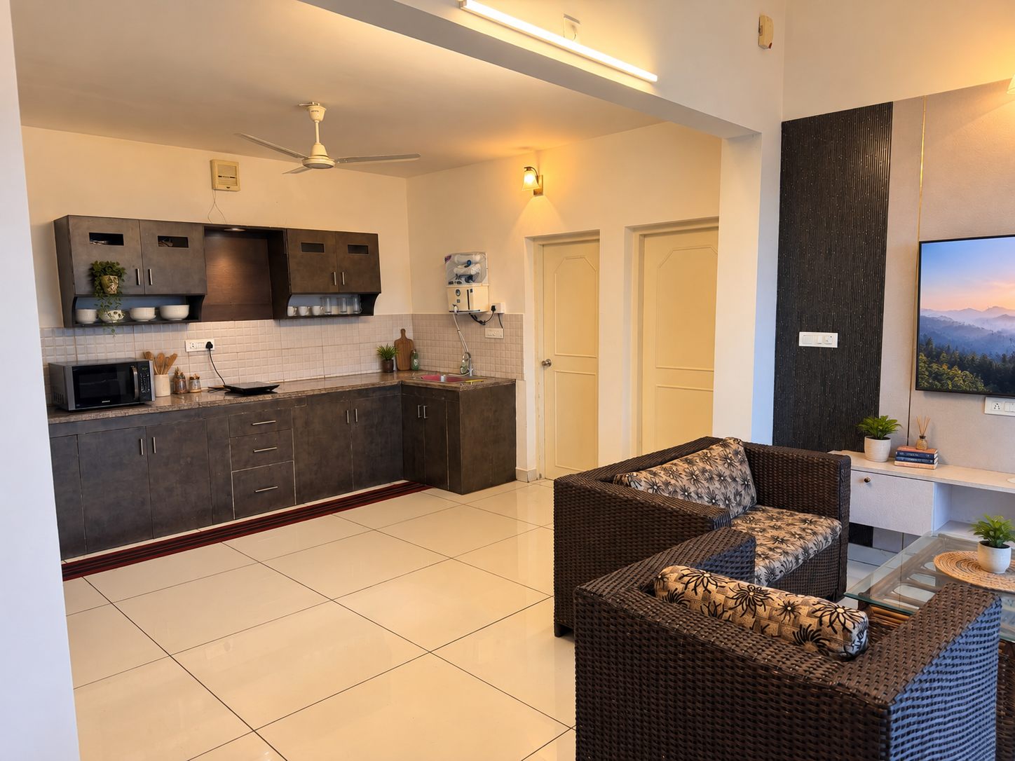 The open 2 BHK living area and kitchen at Green Peaks