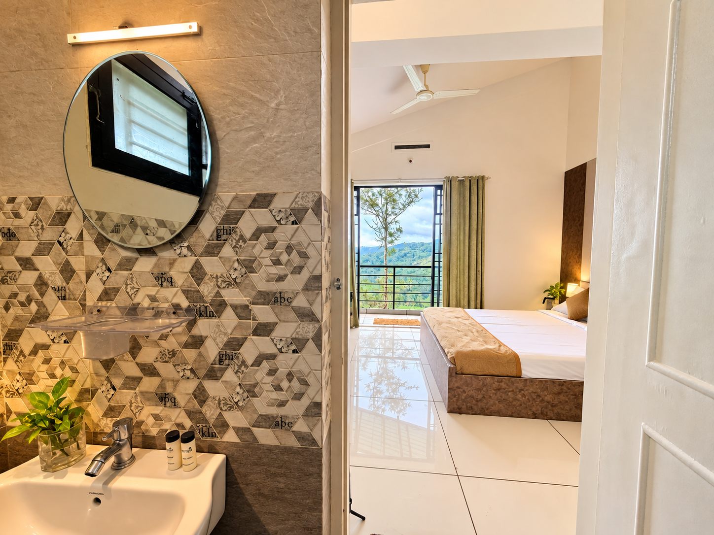 A view from a 2 BHK bathroom through to the bedroom and the hills beyond